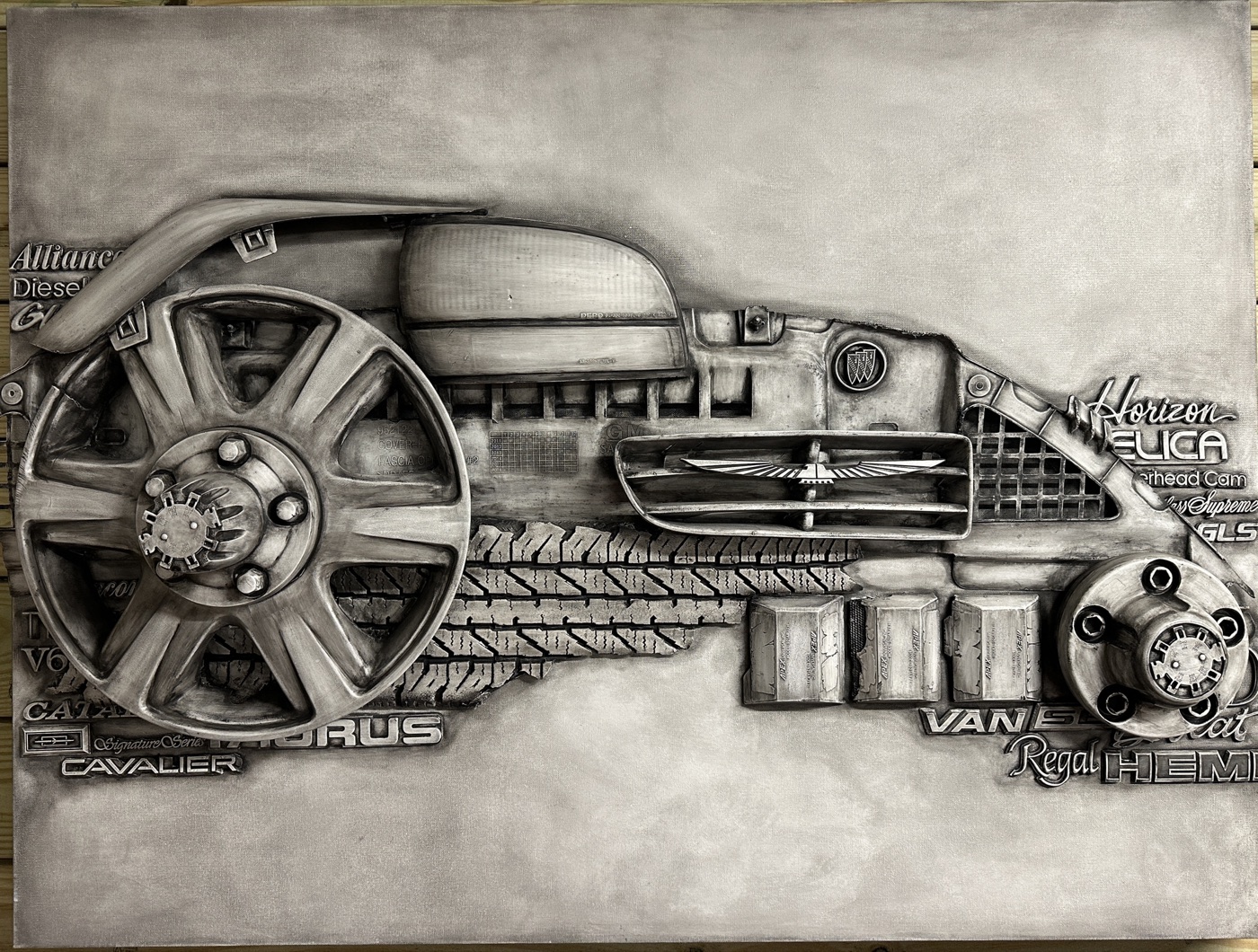 Relief sculpture made from salvaged car parts and emblems